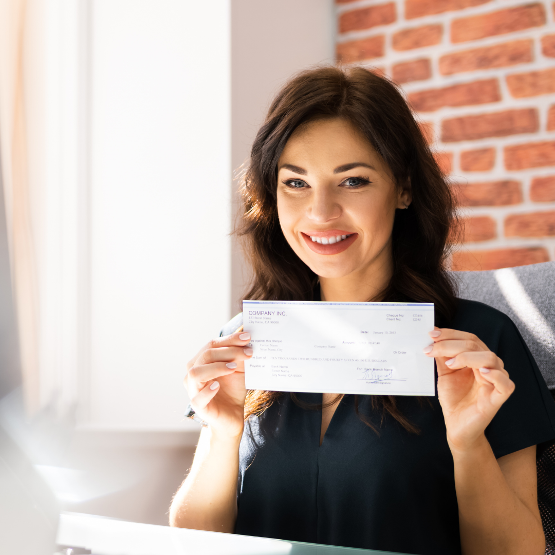 a woman showing her pay check
