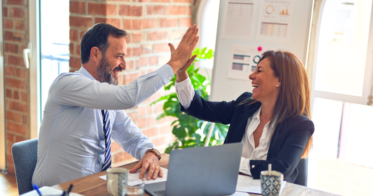 a man and a woman giving high five.